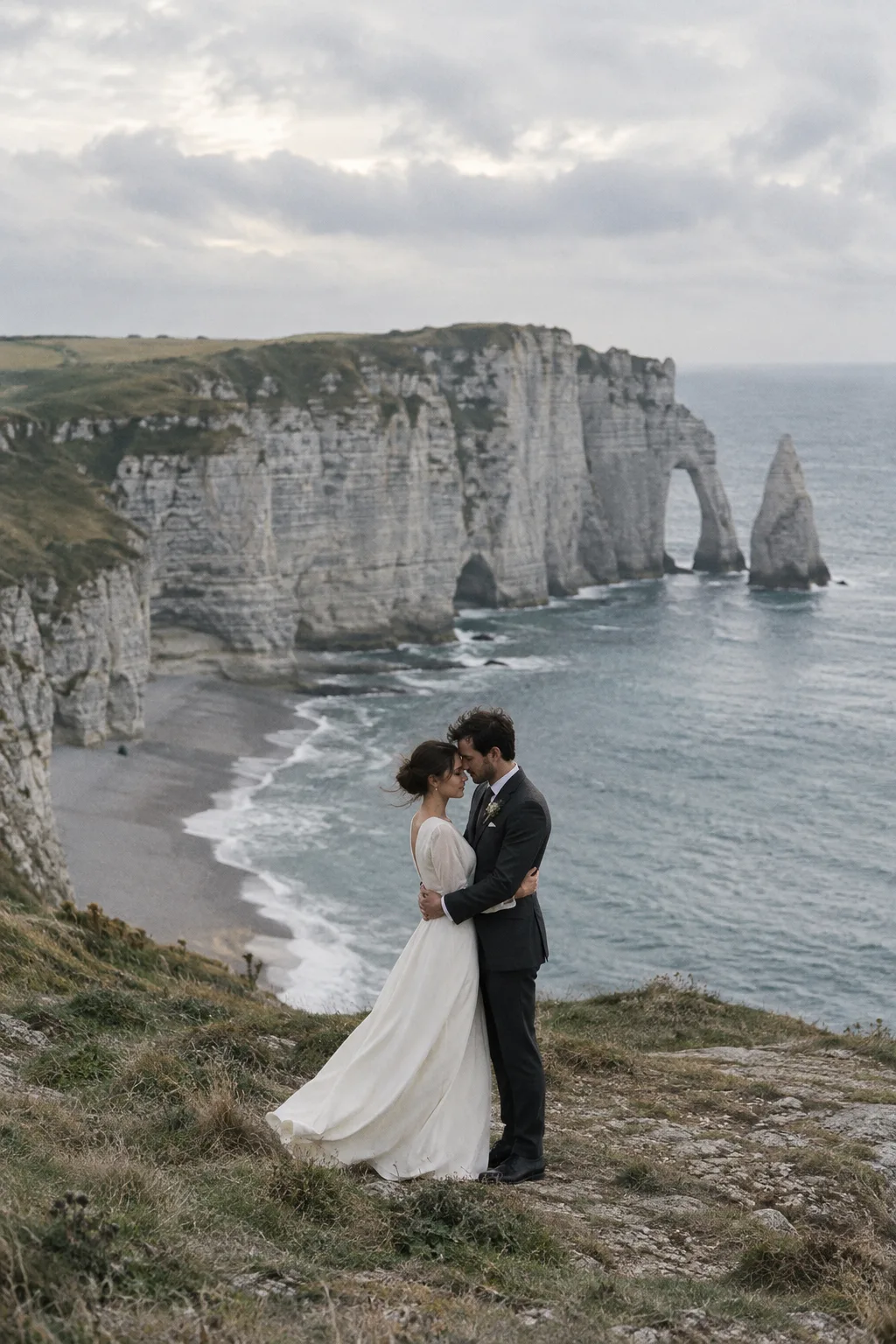 A couple embracing above the Normandy coastline
