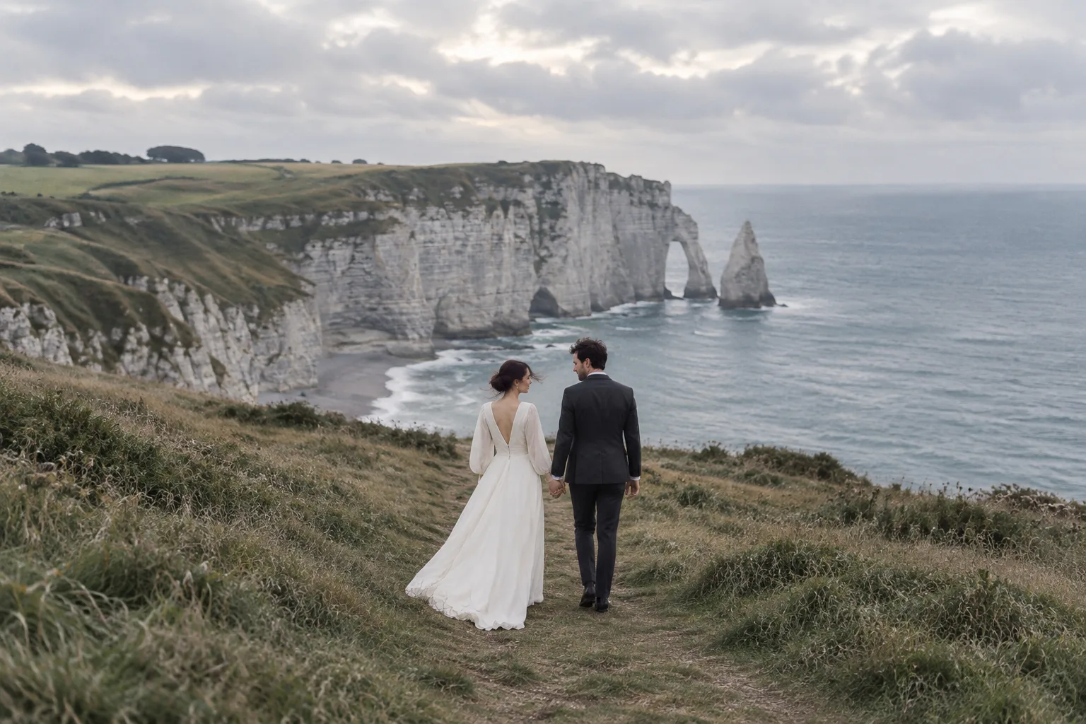 A wedding couple walking above the Normandy coastline